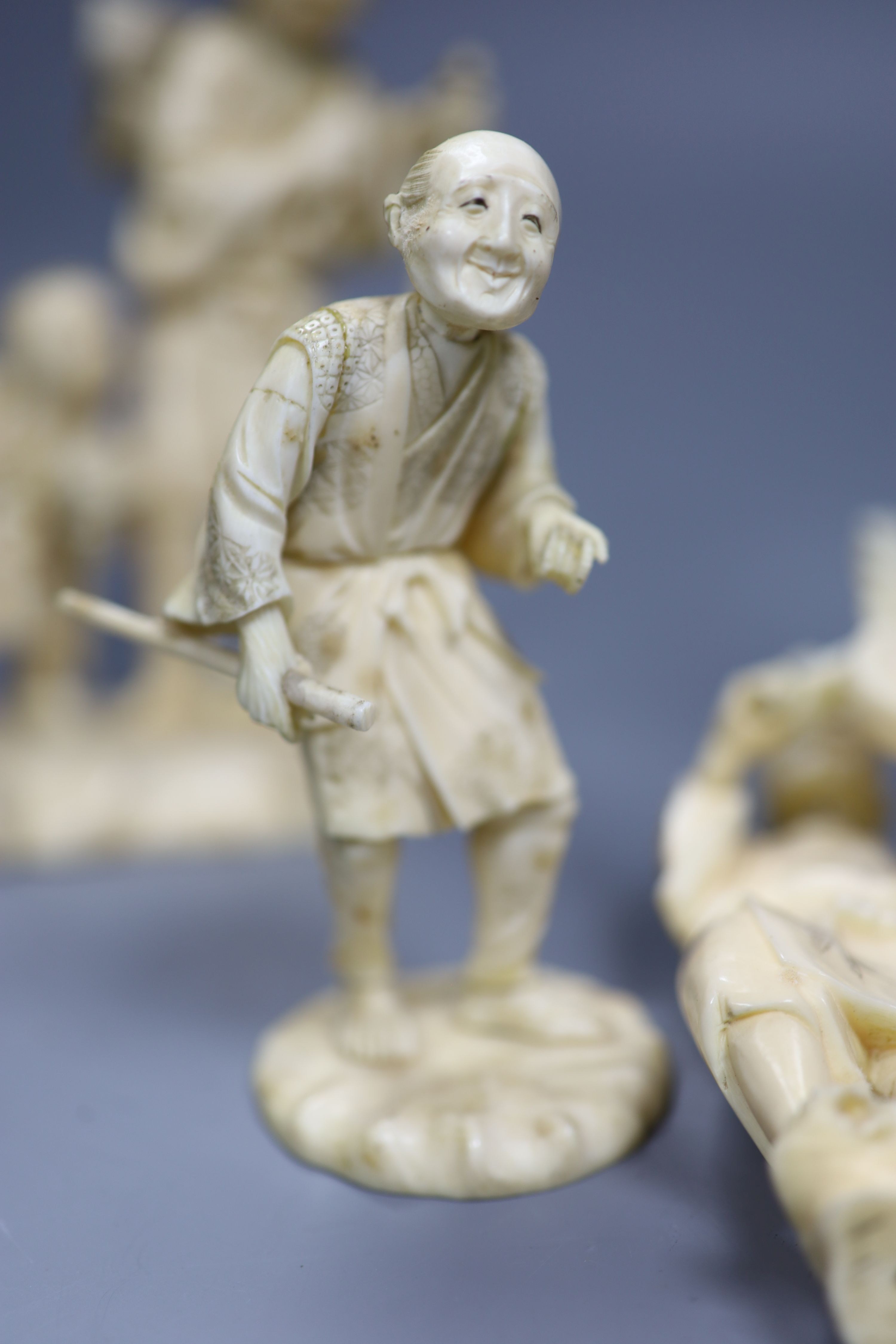 Four 19th century Japanese carved ivory figures, tallest 21cm